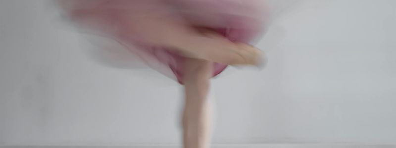 A person in motion, blurred to convey a sense of fluid movement.
