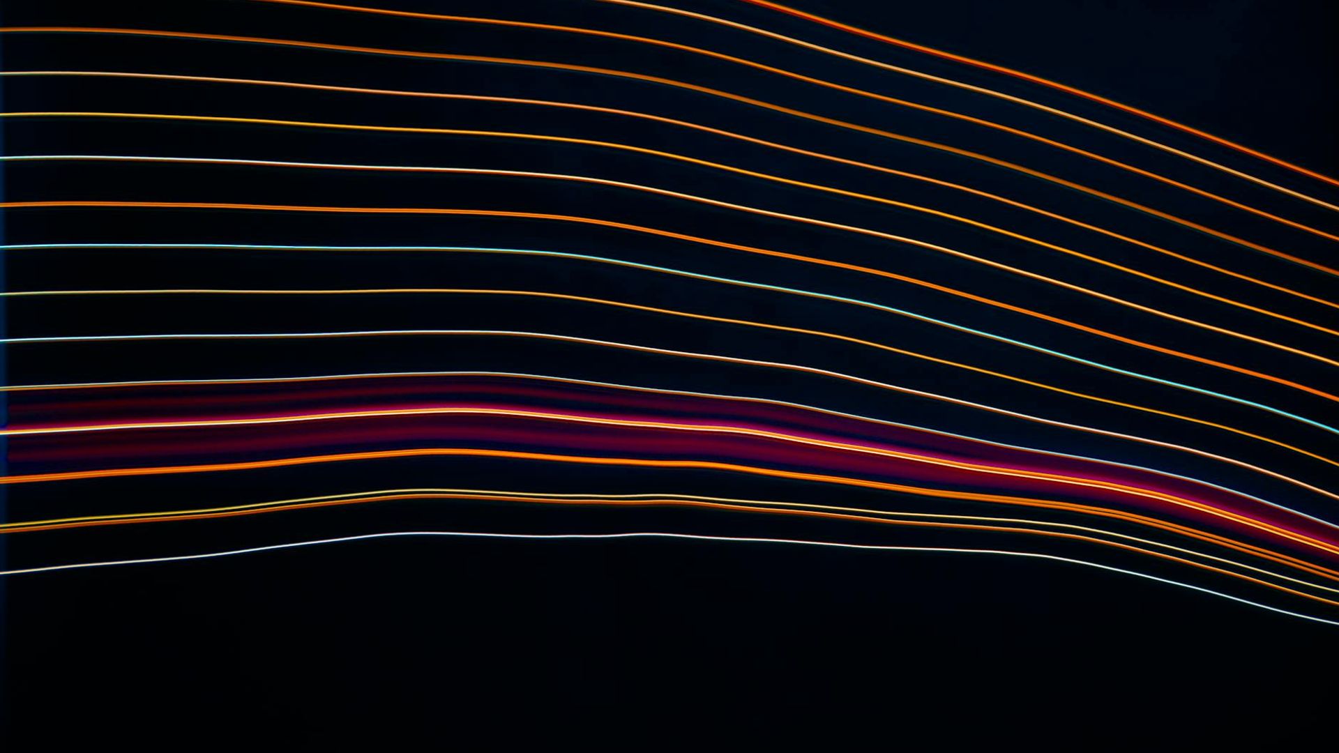 Abstract image showing fluid lines of movement in gold on a dark background.